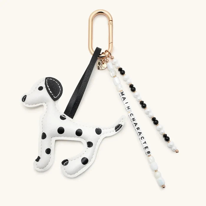 Main Character Dalmatian Bag Charm with black and white beaded tassel on gold carabiner clip