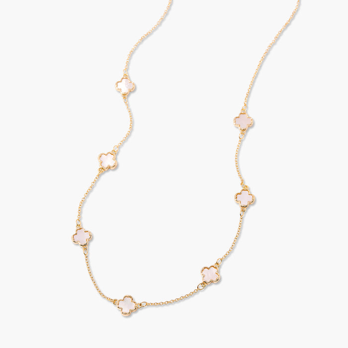 Gold necklace with floral pendants on a white background