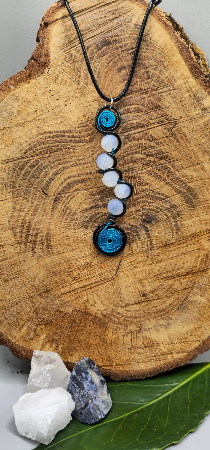 Electric blue, or pink, and black 5 bead twist pendant.