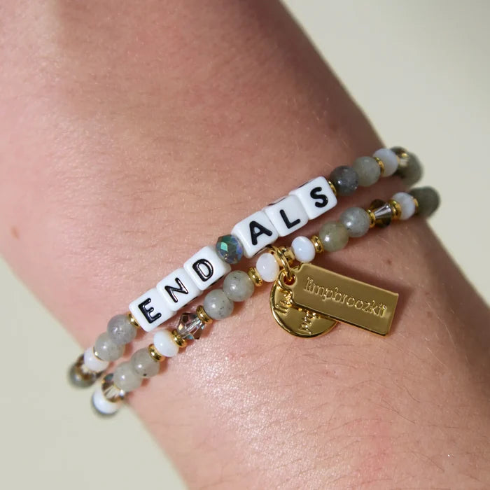 End ALS Bracelet on a wrist with a gold plated LWP tag and a LIMPBROOZKIT tag