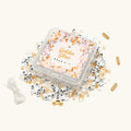 Golden Glow Bead Kit with gold and cream beads spilled around clear storage box