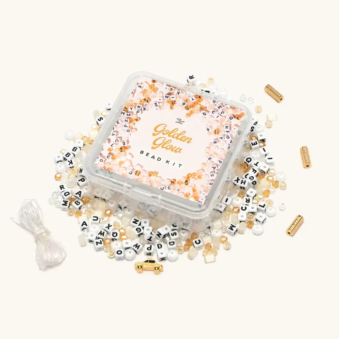 Golden Glow Bead Kit with gold and cream beads spilled around clear storage box