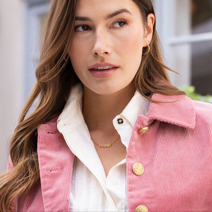 Woman wearing a pink jacket with a blurred background
