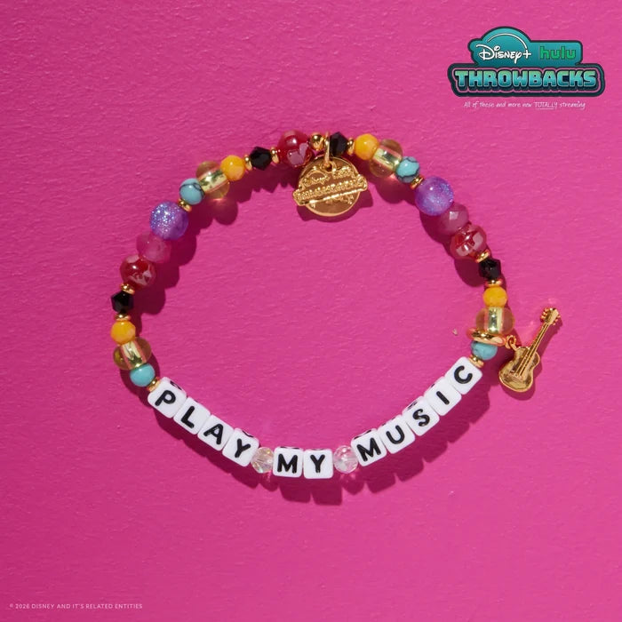 Play My Music Disney+ Hulu Throwbacks bracelet on a hot pink background showing the gold guitar charm and Throwbacks logo tag